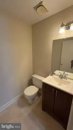 a bathroom with a sink a toilet and mirror