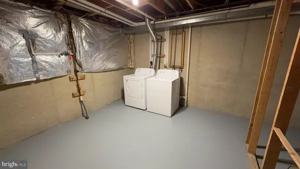 a utility room with a shower and mirror