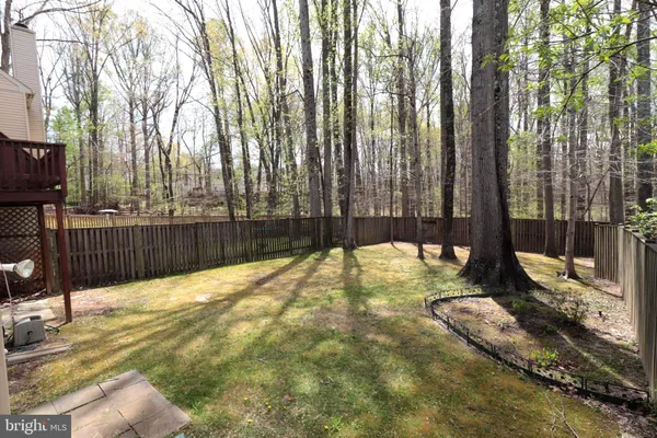 a view of backyard with wooden fence