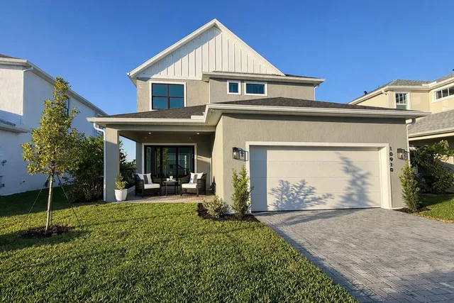 a view of a house with a yard and garden