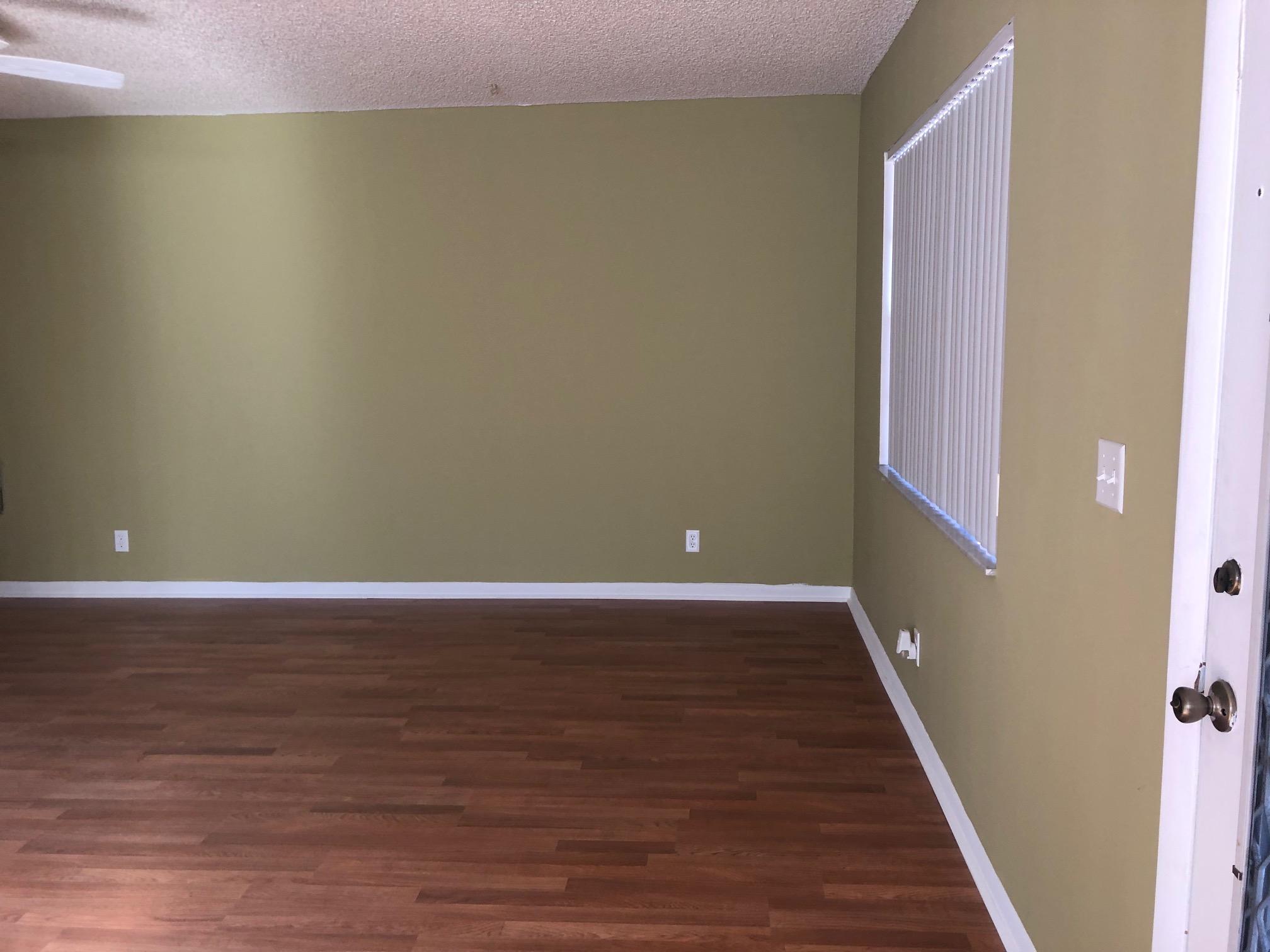 369 Normandy Lane Delray Beach, FL 33484 - Photo 3 of 14 a view of an empty room with wooden floor