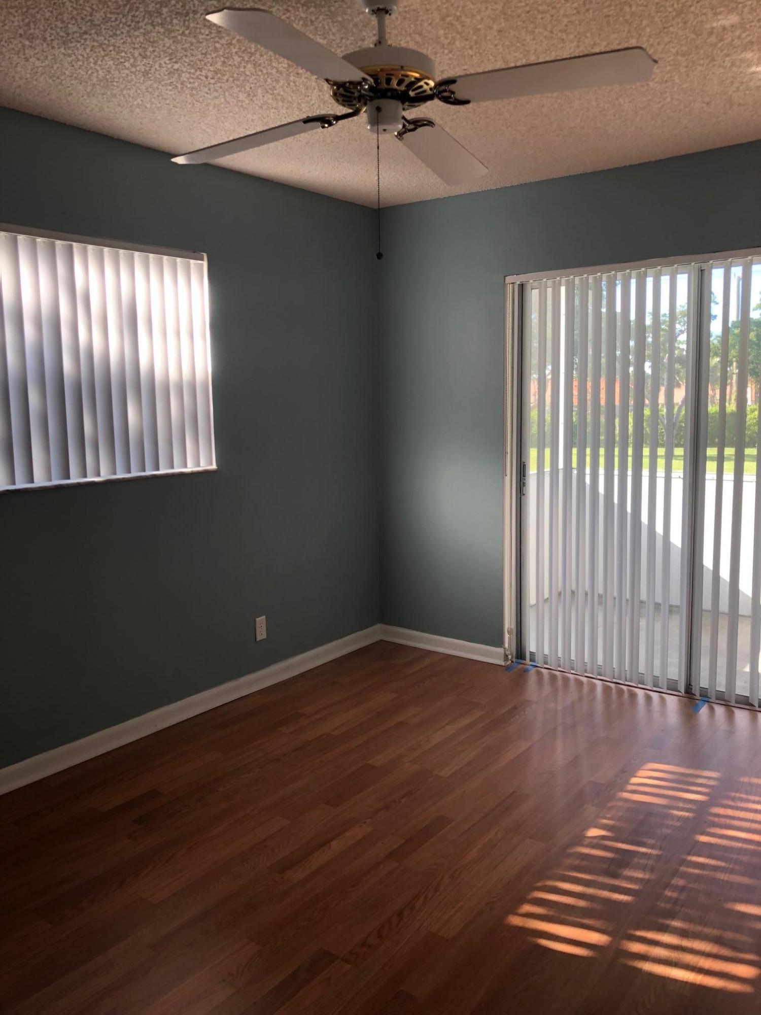 369 Normandy Lane Delray Beach, FL 33484 - Photo 10 of 14 a view of an empty room with wooden floor and a window