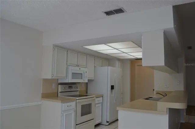 a kitchen with a stove and cabinets