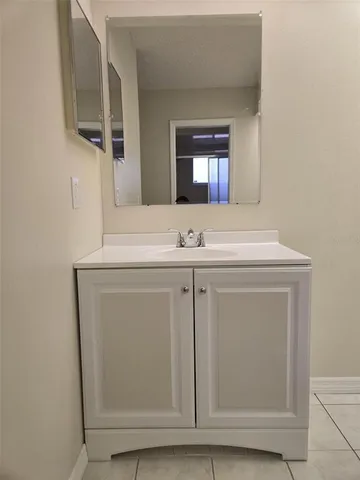 a view of an empty room with closet and a window