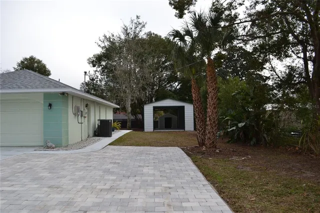 a view of a house with a tree in the background