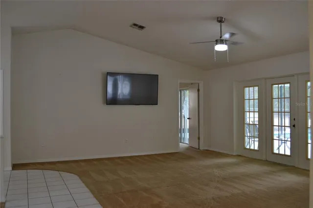 an empty room with windows and entrance
