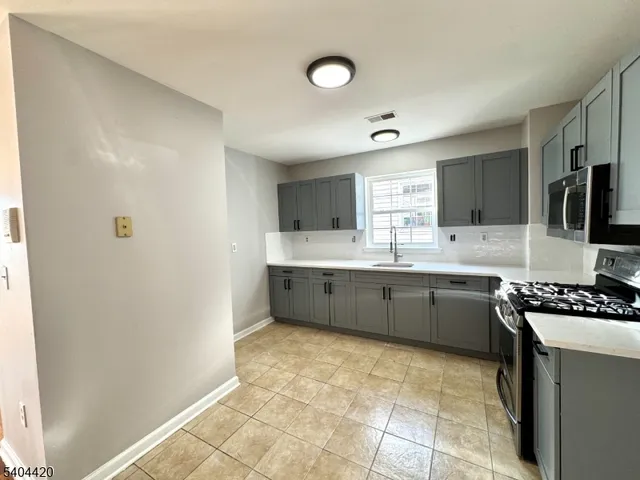 a kitchen with stainless steel appliances granite countertop a sink and cabinets