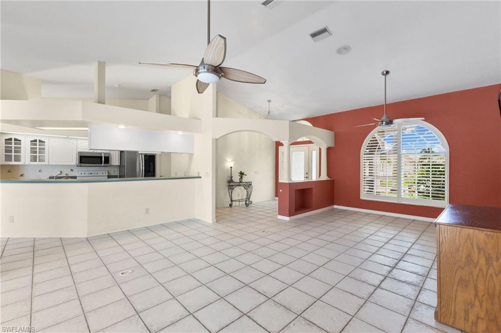 24060 Pyramid Way Punta Gorda, FL 33955 - Photo 11 of 48 Unfurnished living room with ceiling fan, high vaulted ceiling, and light tile patterned floors