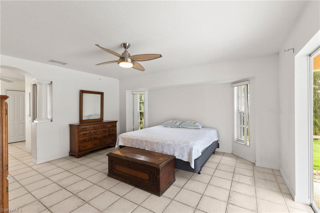24060 Pyramid Way Punta Gorda, FL 33955 - Photo 18 of 48 Primart Bedroom with ceiling fan, decorative columns, and light tile patterned floors