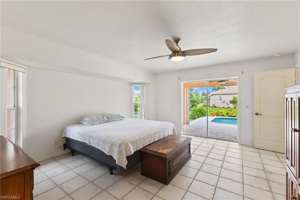 24060 Pyramid Way Punta Gorda, FL 33955 - Photo 20 of 48 Bedroom with ceiling fan, light tile patterned flooring, and access to outside