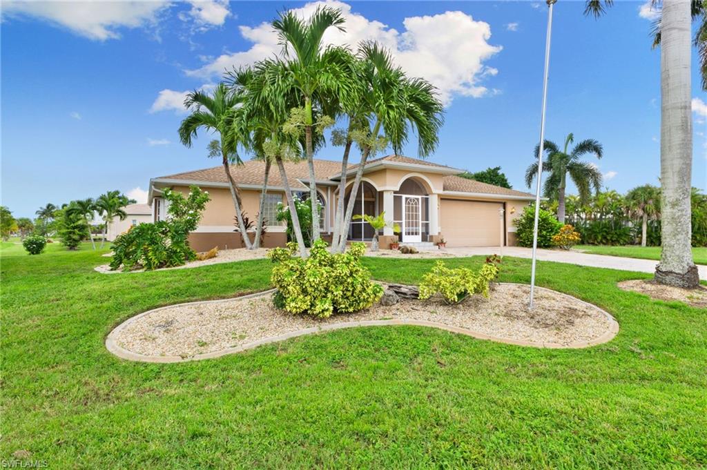24060 Pyramid Way Punta Gorda, FL 33955 - Photo 3 of 48 Mediterranean / spanish-style house with a front lawn and a garage
