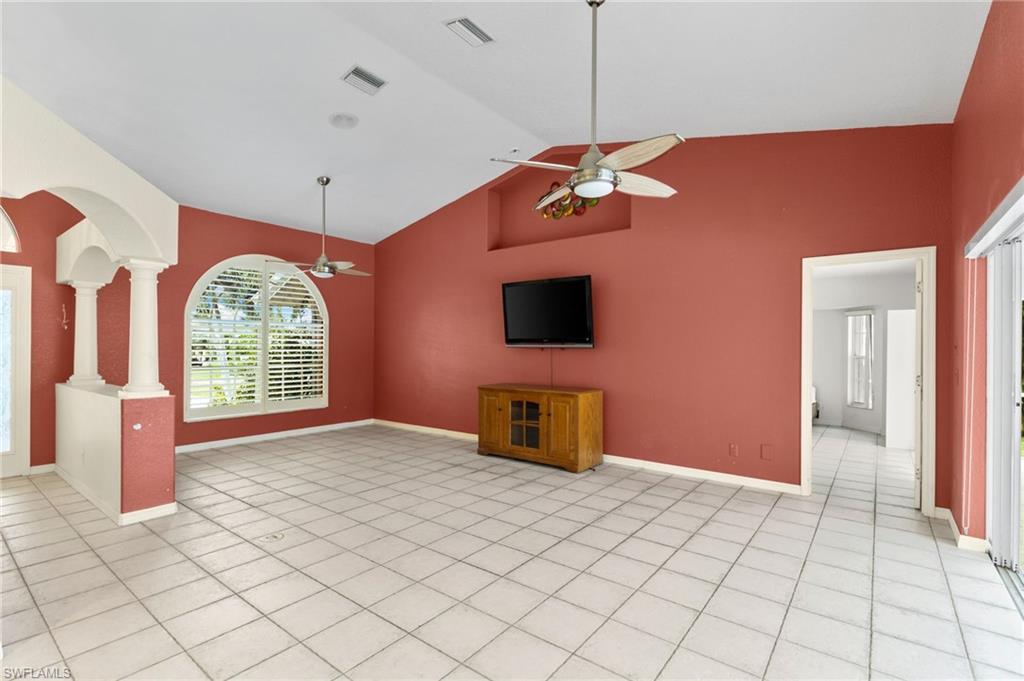 24060 Pyramid Way Punta Gorda, FL 33955 - Photo 5 of 48 Unfurnished living room with ceiling fan, light tile patterned flooring, and high vaulted ceiling