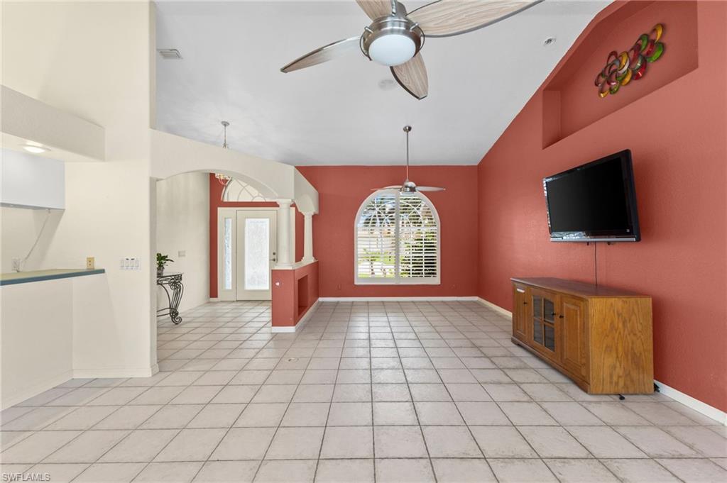 24060 Pyramid Way Punta Gorda, FL 33955 - Photo 6 of 48 Unfurnished living room featuring high vaulted ceiling, light tile patterned floors, and ceiling fan