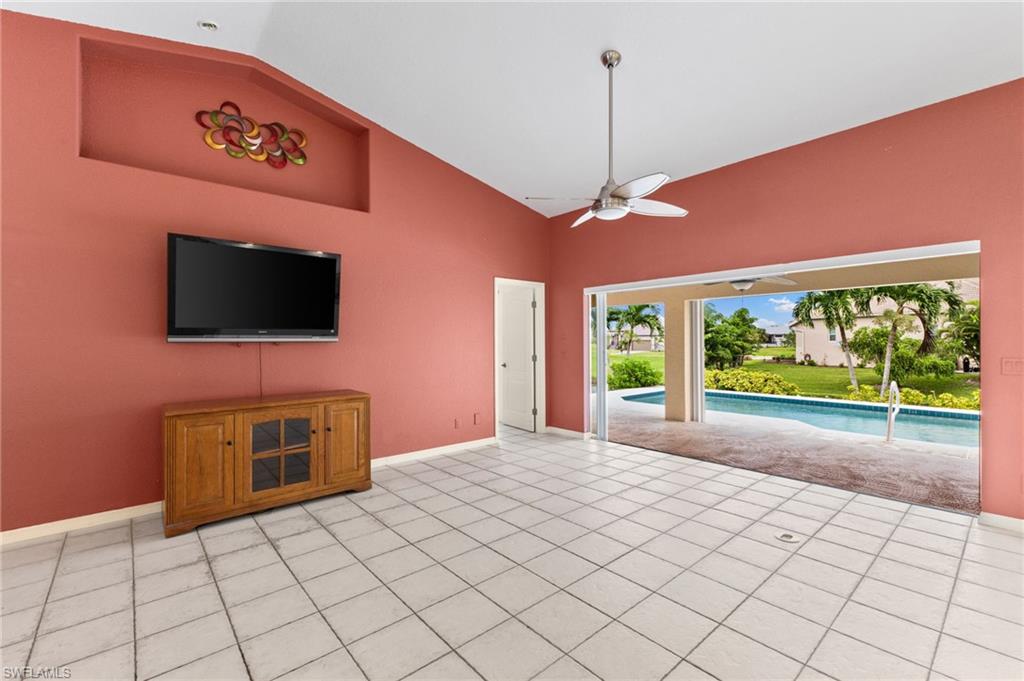 24060 Pyramid Way Punta Gorda, FL 33955 - Photo 10 of 48 Unfurnished living room featuring ceiling fan, high vaulted ceiling, and light tile patterned floors