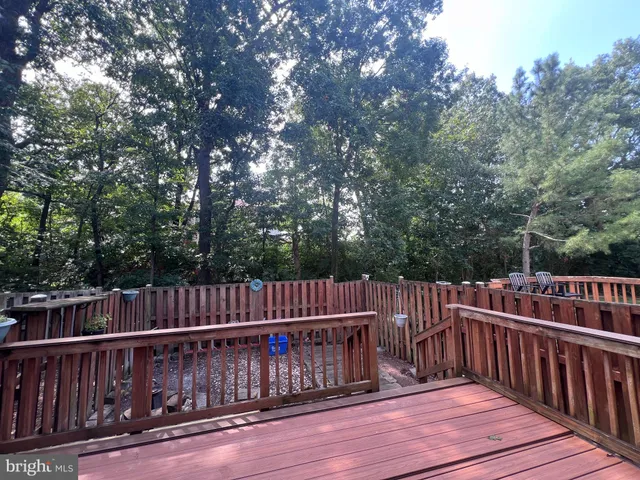 a view of a backyard with a small cabin and wooden chair