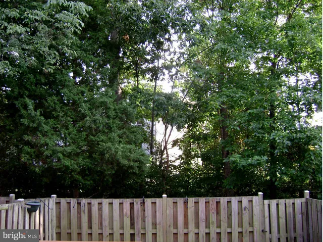 an aerial view of a house with outdoor space and sitting area