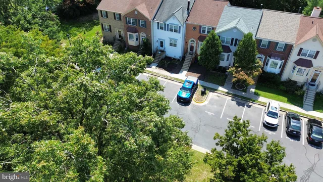 a view of an empty room with wooden floor and a fireplace