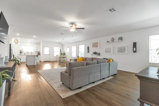 a living room with furniture and kitchen view