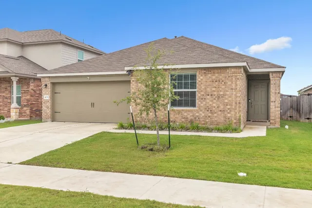 a backyard of a house with potted plants