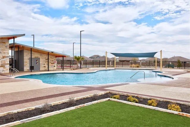 a view of a swimming pool with a yard