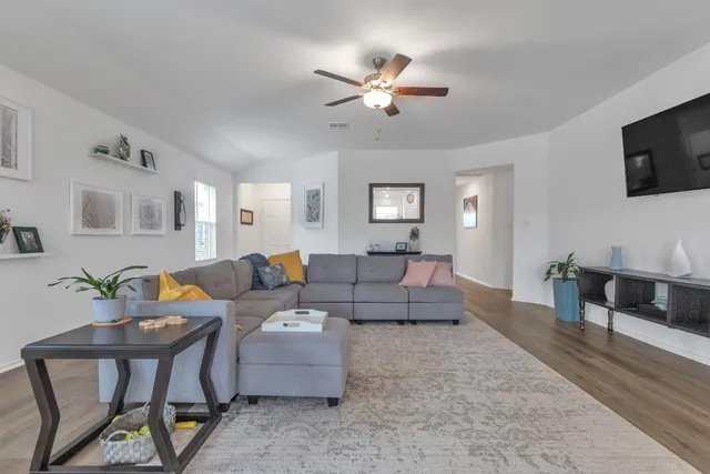 a living room with furniture and a flat screen tv
