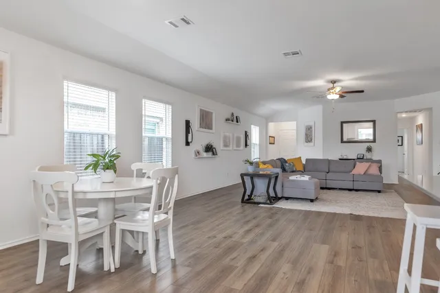 a living room with furniture and wooden floor