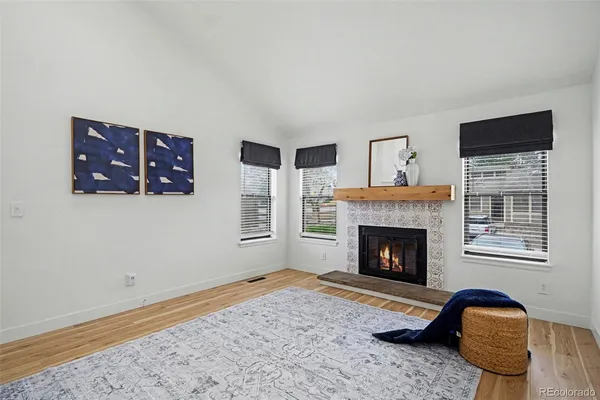 a view of a livingroom with wooden floor and a ceiling fan