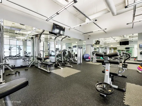 a large room with lots of white furniture