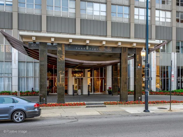 a living room with furniture and large windows