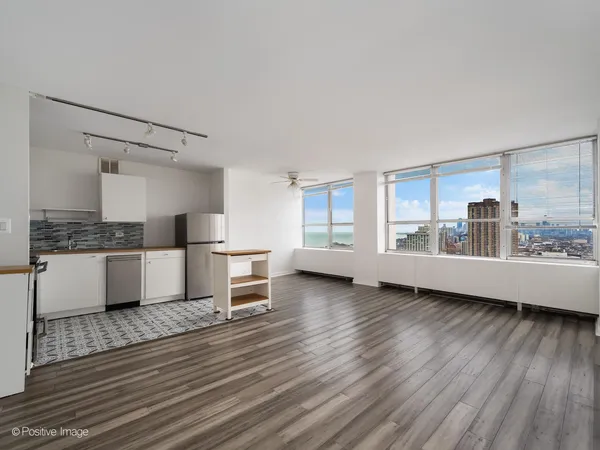 a kitchen with a stove and white cabinets