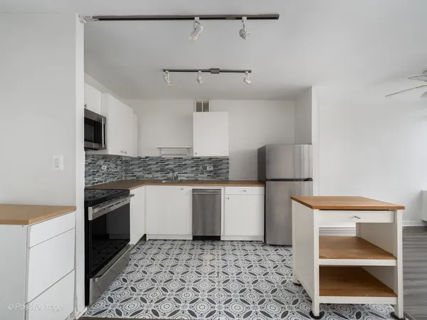 a kitchen with a sink stove and refrigerator