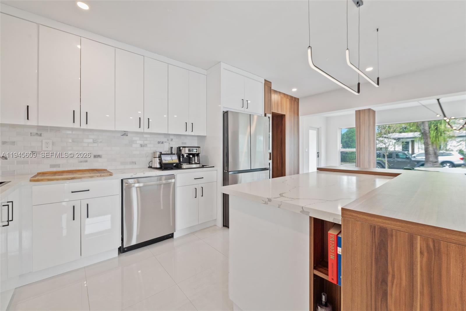 2180 Southwest 20th Street Miami, FL 33145 - Photo 12 of 25 a kitchen that has a lot of white cabinets and stainless steel appliances
