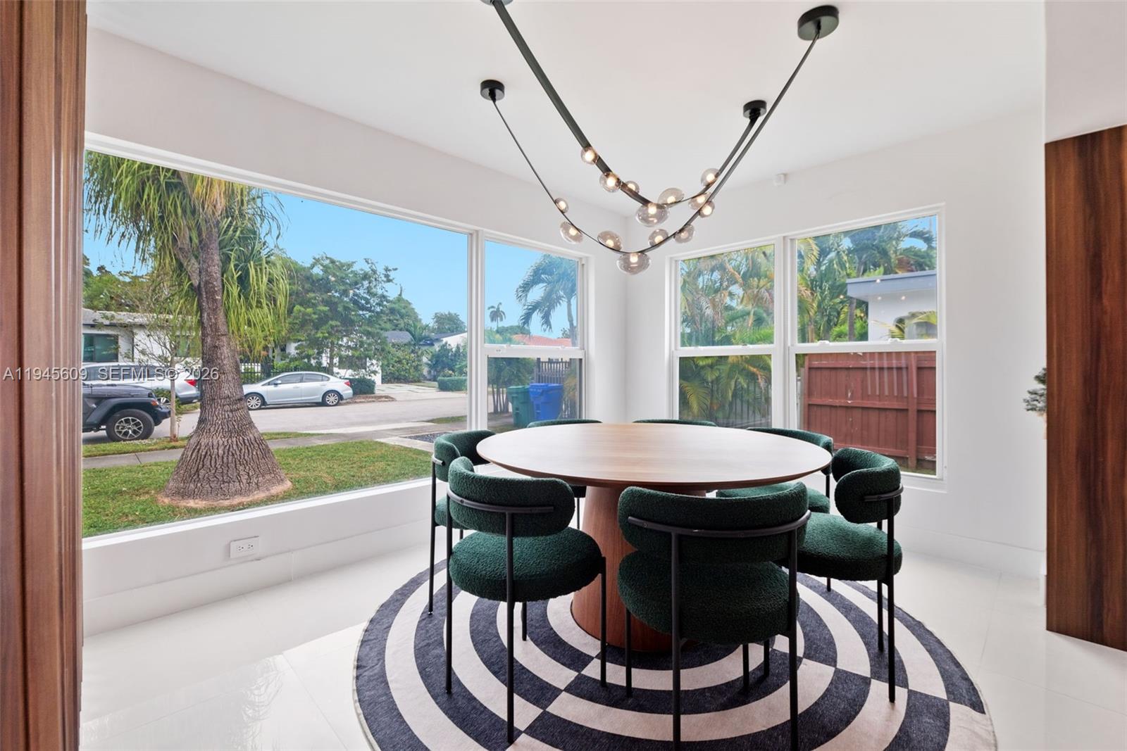 2180 Southwest 20th Street Miami, FL 33145 - Photo 13 of 25 a view of a dining room with furniture wooden floor and a chandelier