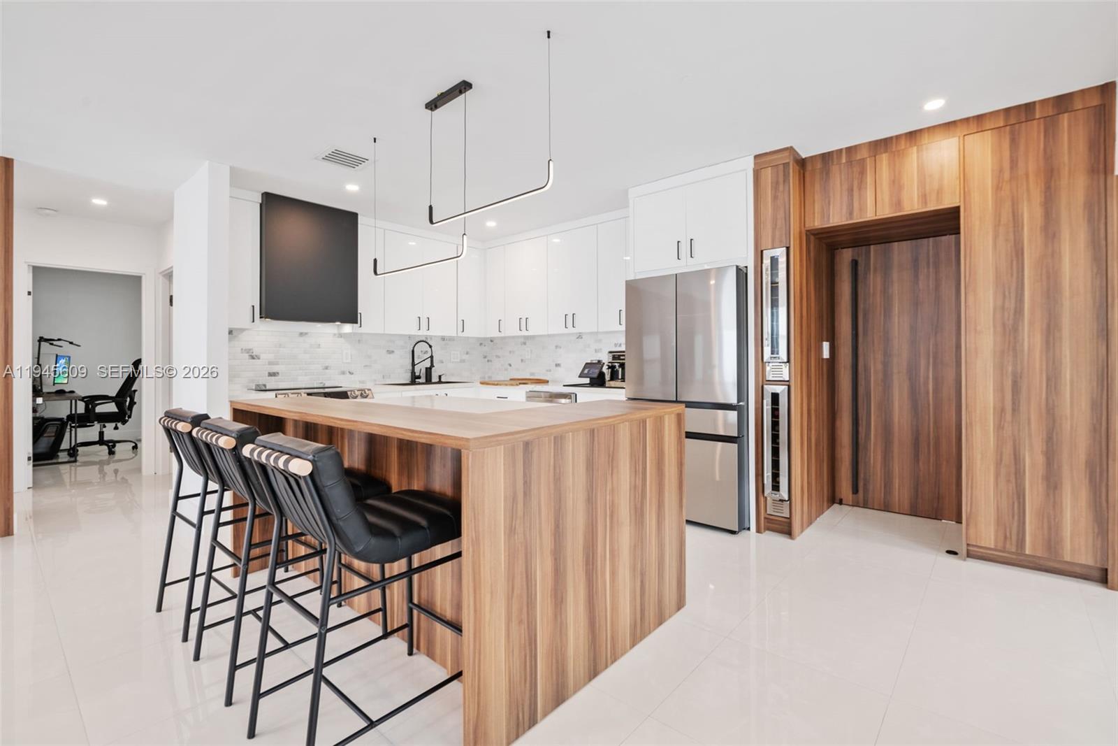 2180 Southwest 20th Street Miami, FL 33145 - Photo 8 of 25 a kitchen with stainless steel appliances granite countertop a refrigerator a sink a stove a dining table and chairs