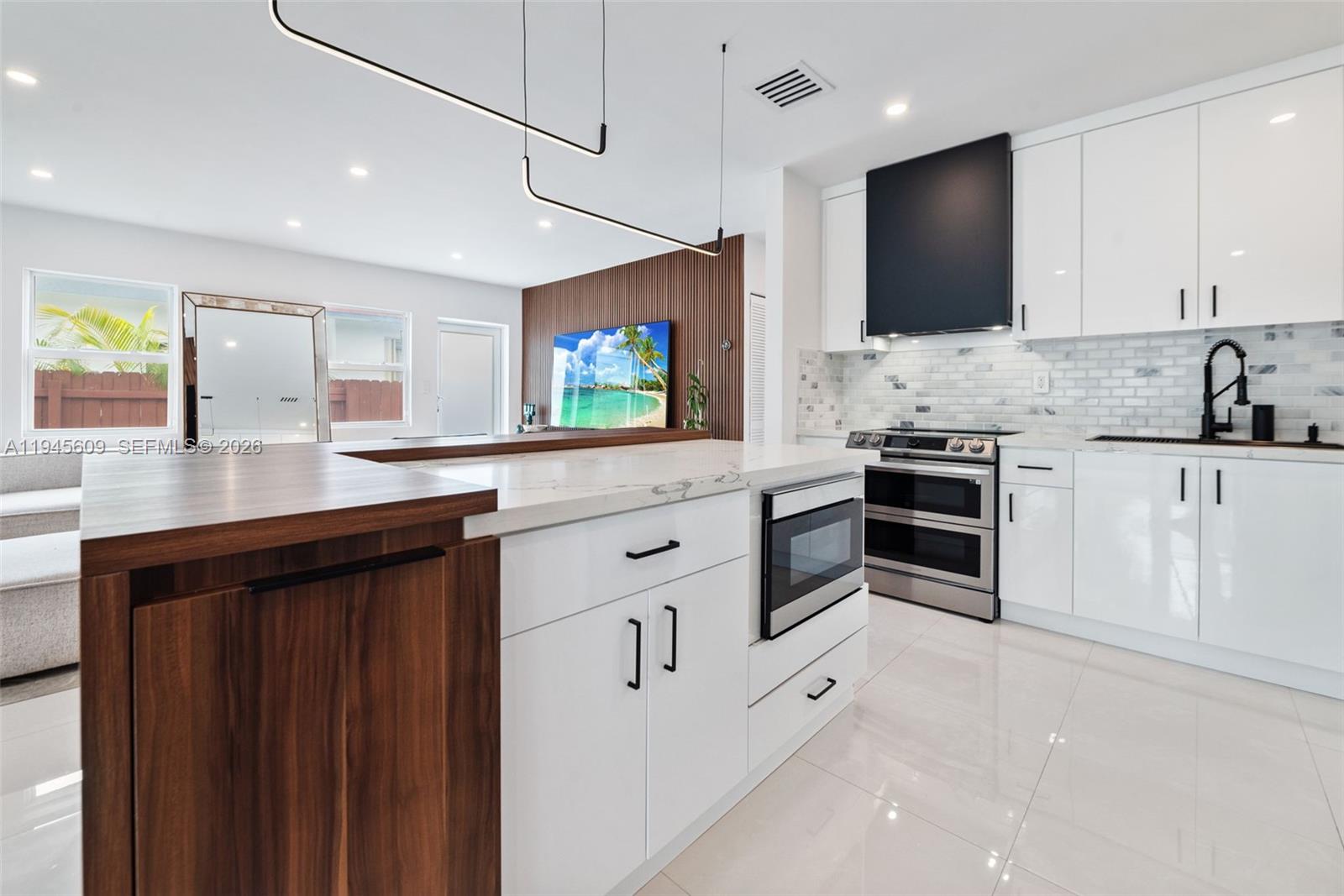 2180 Southwest 20th Street Miami, FL 33145 - Photo 10 of 25 a kitchen with white cabinets and appliances