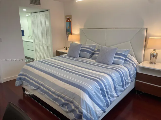 a bedroom with a bed and a mirror