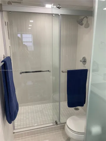a bathroom with a toilet and a shower