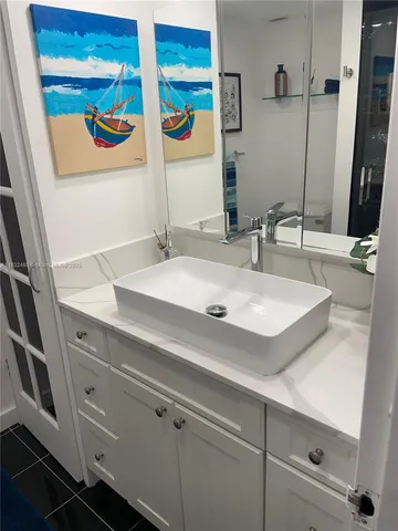 a bathroom with a sink and a mirror