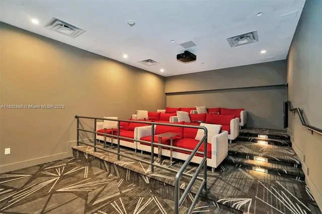 a living room with furniture and floor to ceiling windows