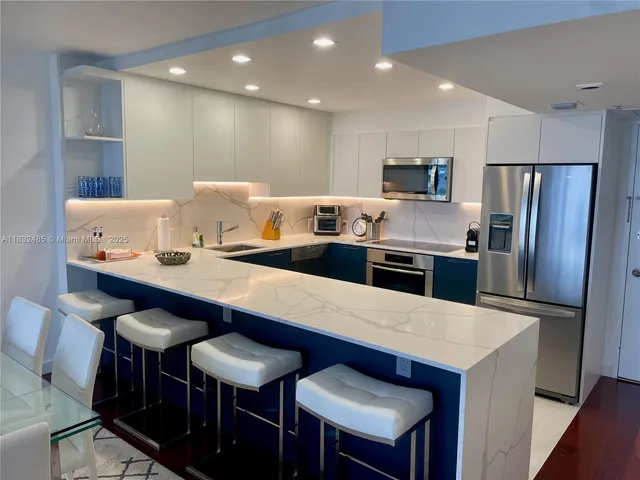 a large kitchen with a table and chairs
