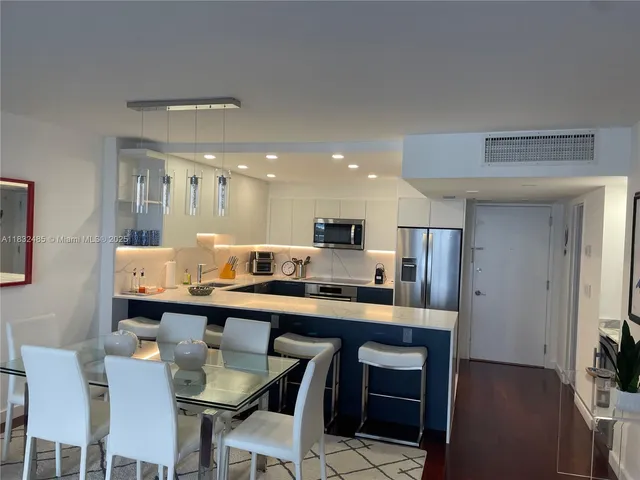 a large kitchen with a table and chairs