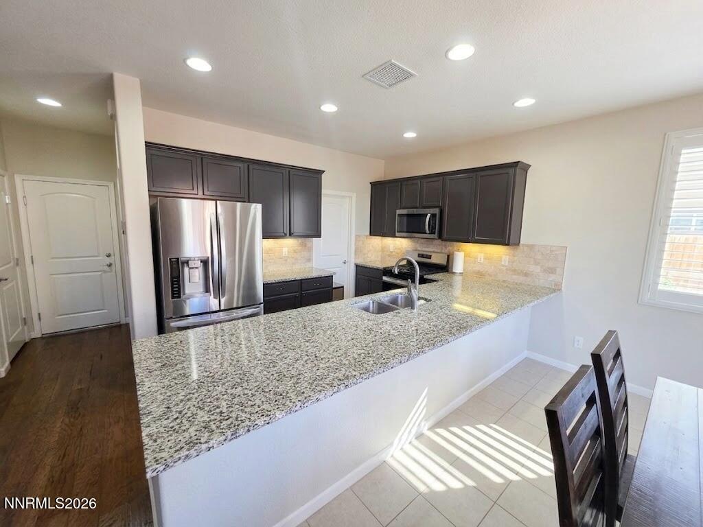 2775 Bonfire Lane Reno, NV 89521 - Photo 13 of 41 a kitchen with stainless steel appliances granite countertop a sink refrigerator and microwave
