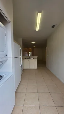 a kitchen with stainless steel appliances a refrigerator sink and cabinets