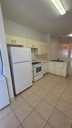a kitchen with stainless steel appliances a refrigerator sink and cabinets