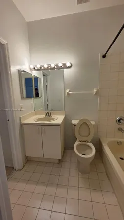 a bathroom with a sink a toilet and bathtub