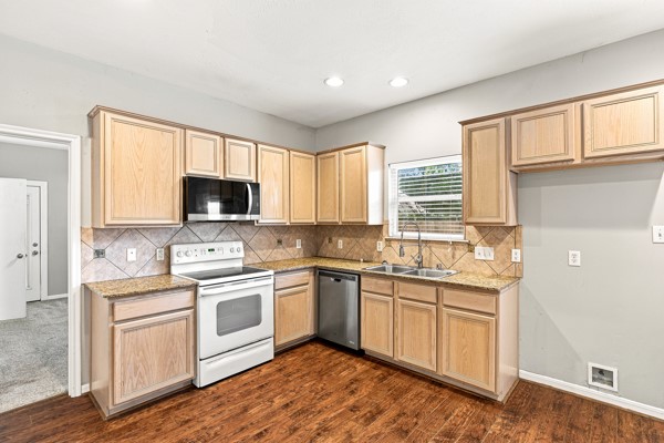 13396 Teel Road Montgomery, TX 77356 - Photo 14 of 50 a kitchen with a sink stove cabinets and wooden floor