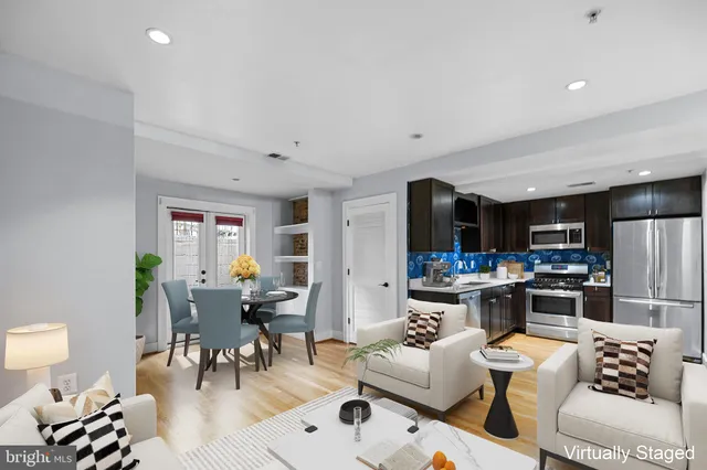 a living room with lots of furniture and kitchen view