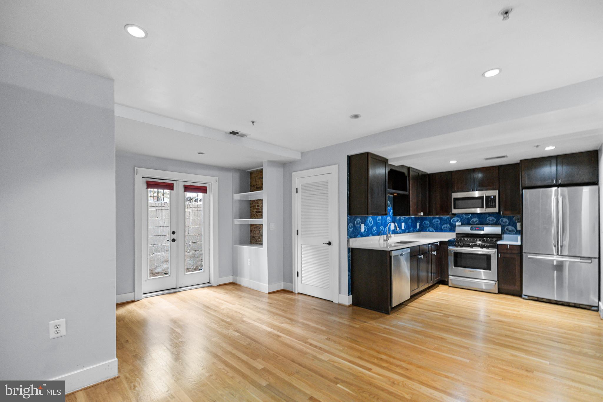 1109 M Street Northwest, Unit 1 Washington, DC 20005 - Photo 14 of 32 a kitchen with stainless steel appliances granite countertop a refrigerator and a stove