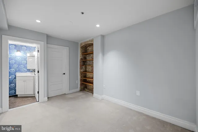 a view of walk in closet with empty racks