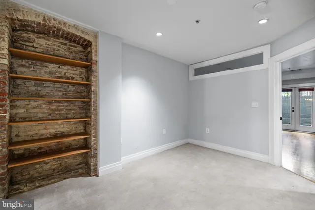 an empty room with a kitchen